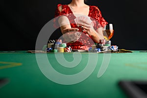A girl plays cards in a casino and raises bets with chips. Blackjack. poker. texas poker. gaming business