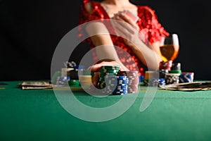 A girl plays cards in a casino and raises bets with chips. Blackjack. poker. texas poker. gaming business