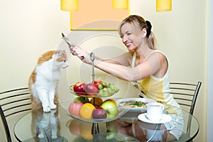 The girl plays with a cat kitchen