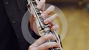 The girl plays the clarinet. Clarinet close-up.