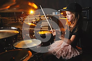 Girl plays drums in recording studio