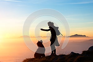 Girl plays with his dog in the mountain