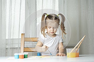 Girl plays and paints with oil