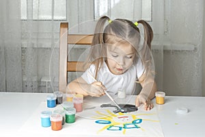 A girl plays and paints with oil