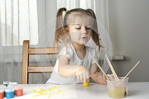 a girl plays and paints with oil