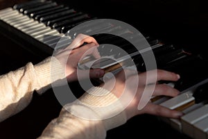 The girl plays the piano, typing chords with the keys