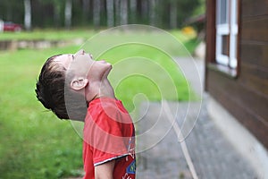 Girl plays in rainy weather Child jumping in puddle and mud in the rain