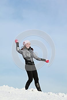 Girl plays snowballs in winter