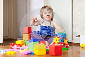 Girl plays with toys in home interior