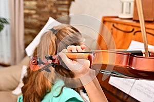 The girl plays the violin accompanied by the piano. Education at the music school