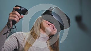 The girl plays virtual reality games in the club.