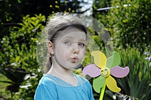 Girl plays with windmill