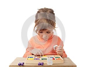 Girl plays in wooden figures in form of numerals photo