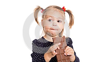 Girl with pleasure eats chocolate