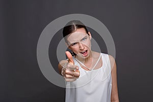 Girl pointing finger and shouting at camera