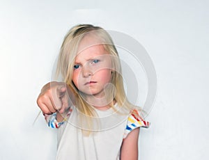 girl points a finger forward on a white background