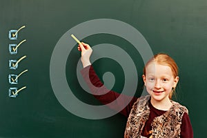 Girl points to the list on the board