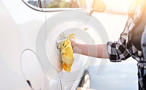 Girl polishing car door handle