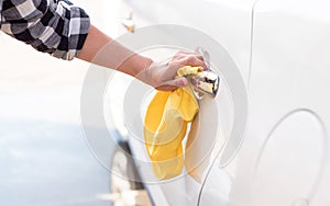 Girl polishing car door handle