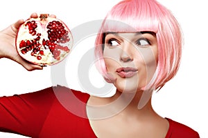 Girl with pomegranate. Pink hair. Makeup