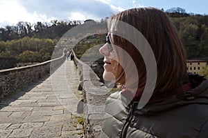 A girl on the Ponte della Maddalena also called Ponte del Diavolo in Borgo a Mozzano