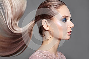 Girl with Ponytail Hairstyle. Shiny Straight Hair, Fashion Makeup on Model Face. Woman with Healthy Skin, Party Make-up