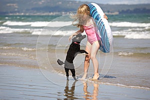 Girl and poodle at beach