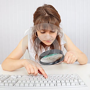 Girl with poor eyesight and computer keyboard