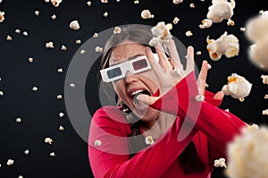 Girl, popcorn and 3d glasses with scream while watching movie, film or horror by dark background. Fantasy, face and