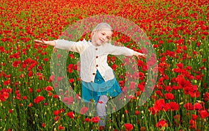 Girl in poppies, happiness and freedom, beautiful spring nature. Happy kid resting on a beautiful poppy field. Child
