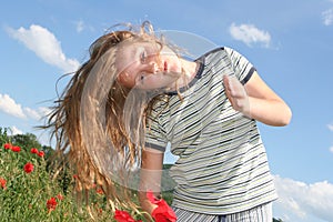 Girl with poppies over sky