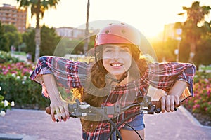 Girl portrait on bicycle with helmet smiling