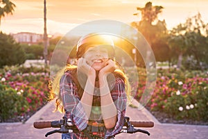 Girl portrait on bicycle with helmet smiling