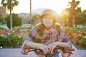 Girl portrait on bicycle with helmet smiling