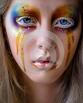 Girl portrait with creative colorful rainbow makeup