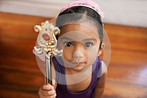 Girl, portrait and cute costume with wand for halloween, fantasy and dress up with fairytale clothes. Child, home and
