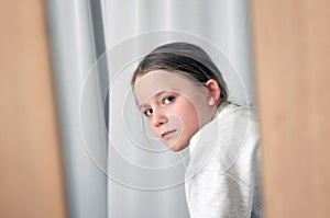 Girl portrait looking through mirror