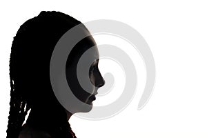 The girl portrait profile in silhouette shadow on studio