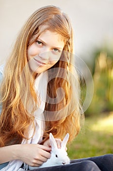 Girl, portrait and rabbit smile outdoor for pet love connection, bonding or happy play. Female teenager, face or bunny