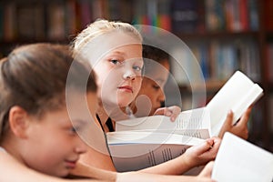 Girl, portrait and reading books in classroom for education, learning and English language, literature or school