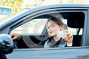 Girl portrait sititng in her car and driving license