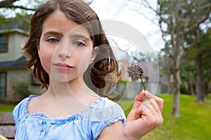 Girl portrait with sweetgum spiked fruit on park photo