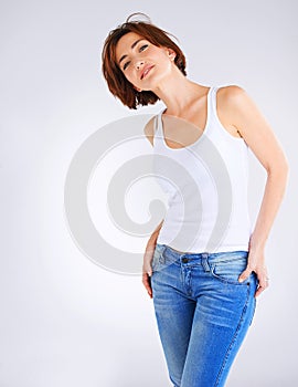 Girl, portrait and tank top for fashion in studio with confidence, attitude and jeans for trendy style. Woman, organic