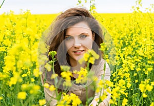 Girl portrait in yellow flower field
