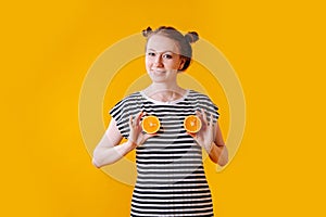 Girl portraying her breast with halves of oranges