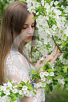 Girl posing against a background of flowering trees