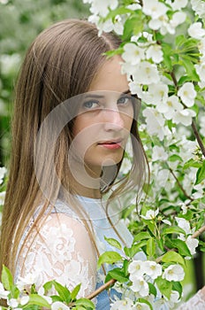 Girl posing against a background of flowering trees