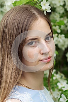 Girl posing against a background of flowering trees