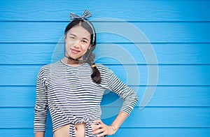 Girl posing against colorful wooden backdrop