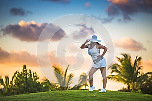 Girl posing on the golf court in tropical resort Punta Cana